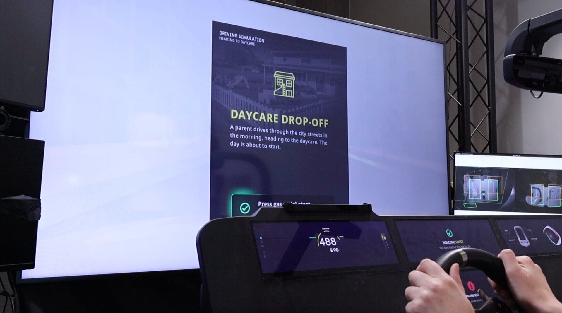 A driving simulation screen showing the "Daycare Drop-Off" scenario with a description of a parent's morning routine heading to daycare.