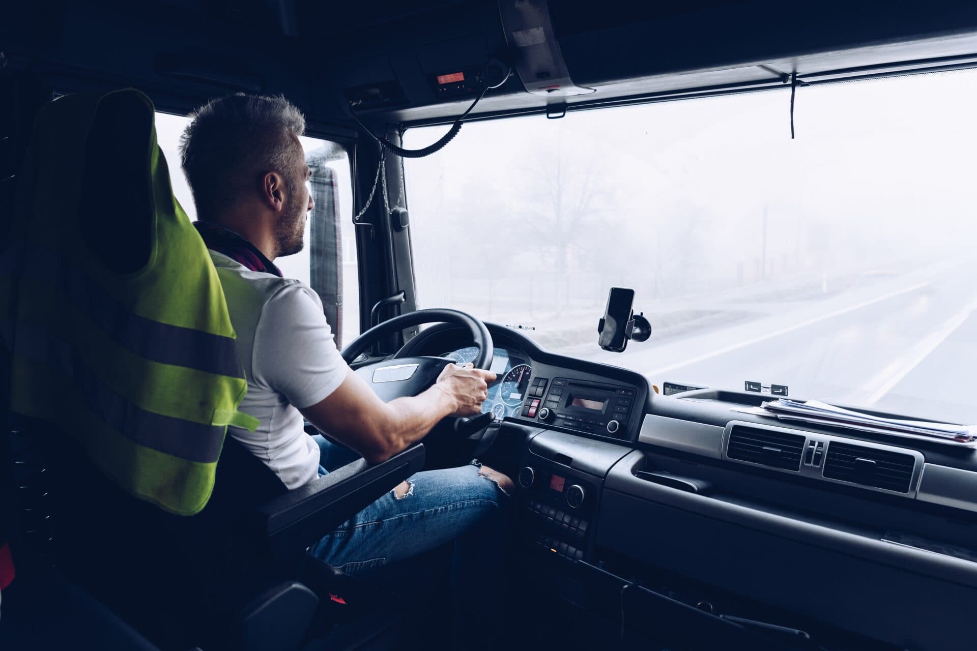 Driver at the wheel of a truck at work.