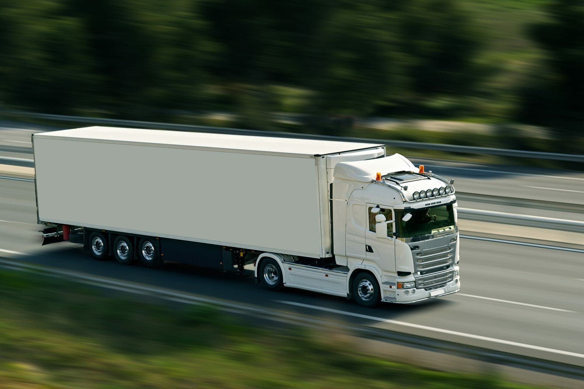 A truck driving fast on a road