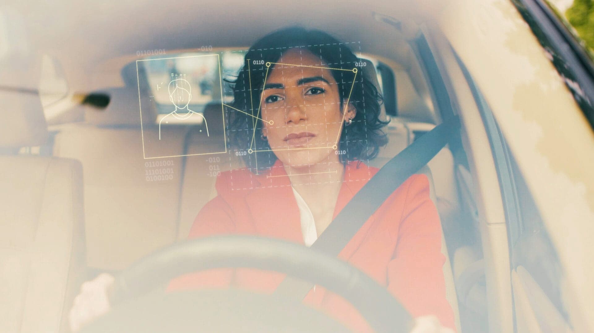 Woman in a car with driver monitoring system metrics overlay
