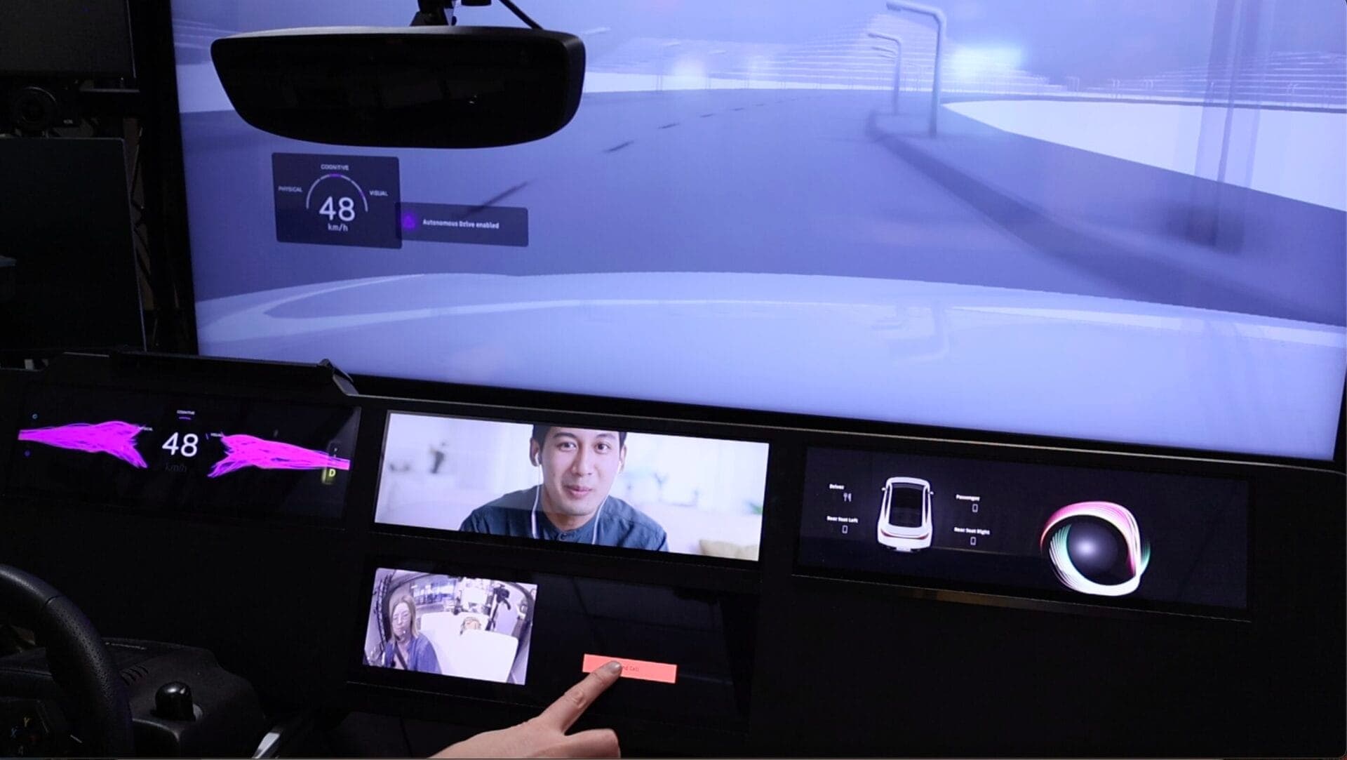 A driving simulator featuring an interface with speed metrics, autonomous driving mode, and an in-cabin video call interaction.