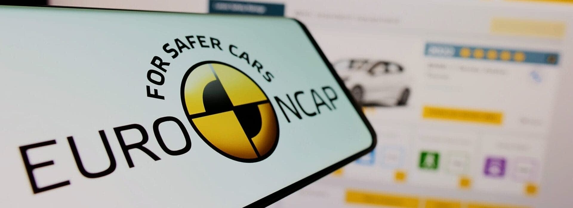An image of a phone screen showing the Euro NCAP logo and a computer screen showing Euro NCAP's website