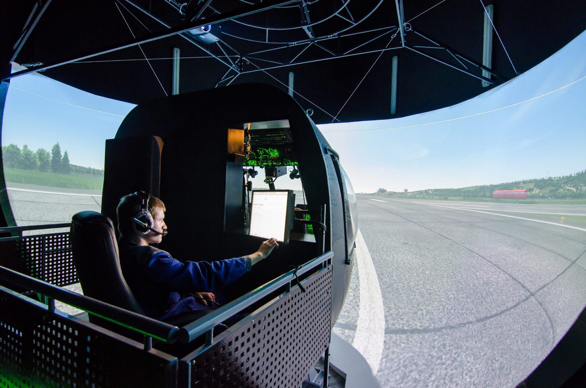 Participant using a Mi-8 helicopter simulator with realistic visuals and control systems, highlighting complex environments for applied eye tracking.