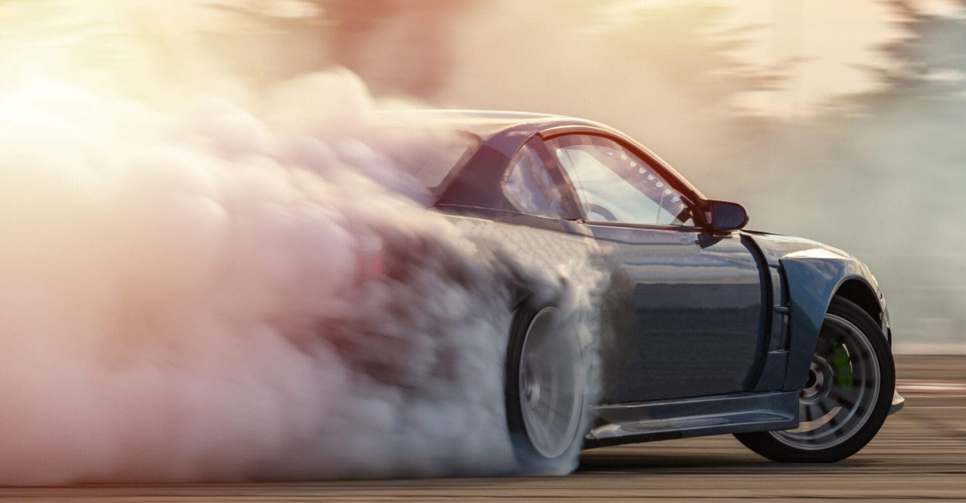 Car drifting, Blurred image diffusion race drift car with lots of smoke from burning tires on speed track